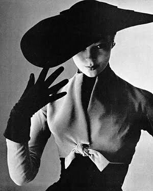 a woman with black hats and gloves