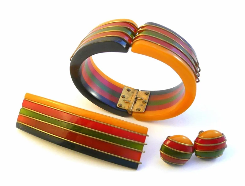 Multi-coloured Bakelite bangle bracelet, earclips, and hairclip from the 1930s.